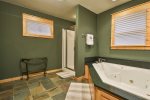 Master bathroom with tub and walk-in shower